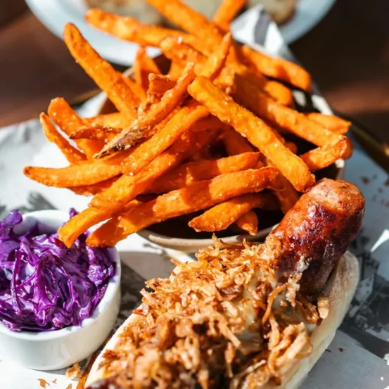 Gourmet hot dog with sweet potato fries