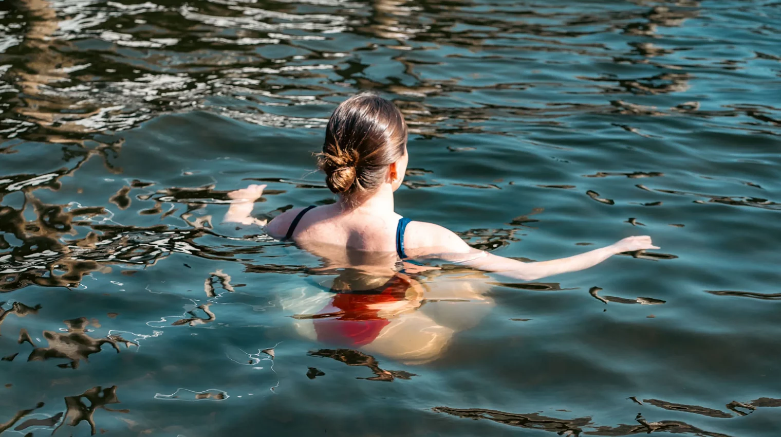 Woman wild swimming in Lake Windermere