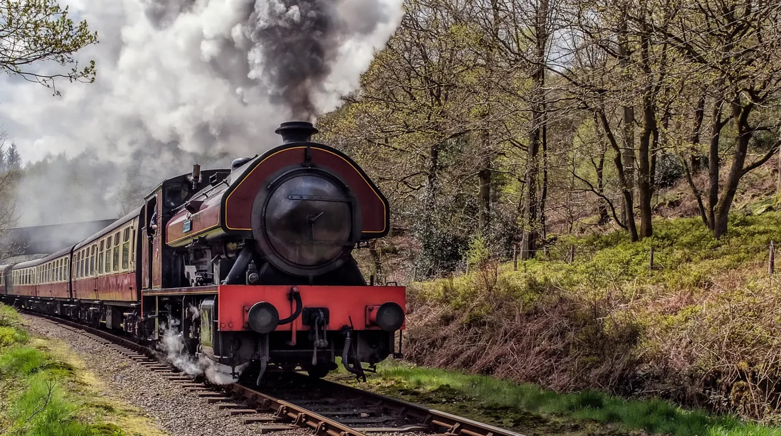 black and red steam train in countryside