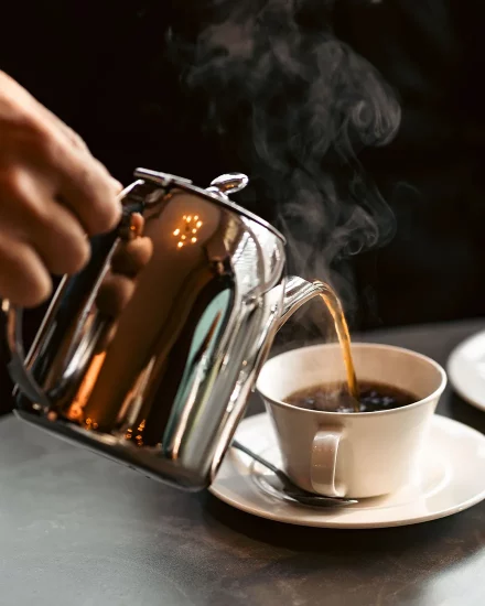 Coffee being poured into cup for business meeting