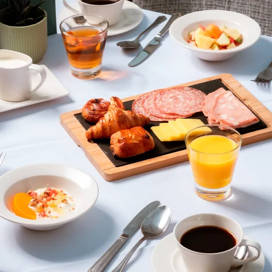 White tablecloth laid out for a continental breakfast