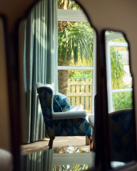 Chair in reflection of traditional mirror