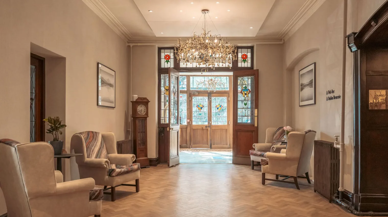 The sophisticated hotel entrance and lobby with oak wood doors and parquet floor