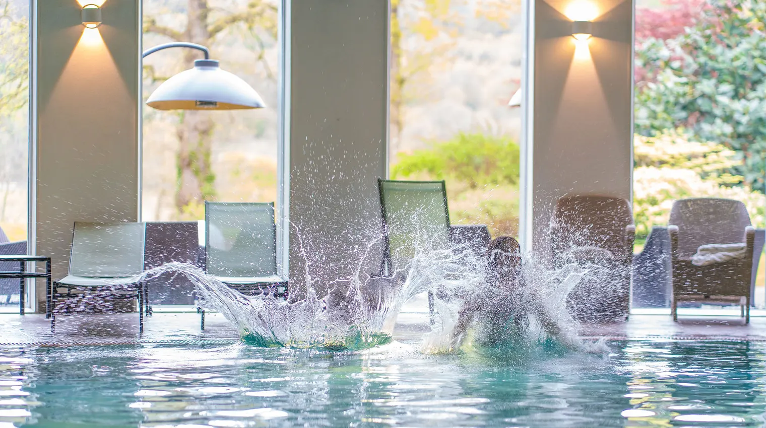 Two children jump into pool with a splash