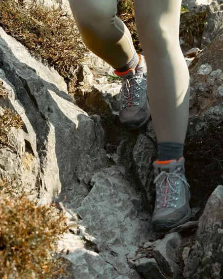 Image link close up of boots of walker walking down trail