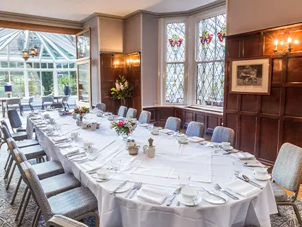 a wood panelled entertaining space with a large table laid out