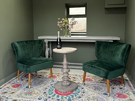 A small space with modern floral decor and two chairs and a table