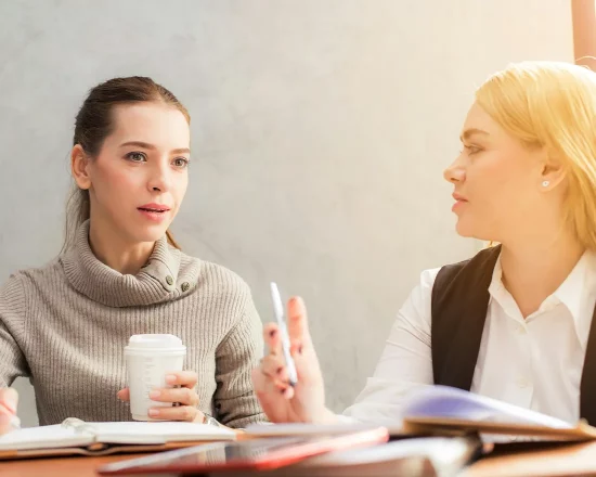 Casual business brainstorming between two business women