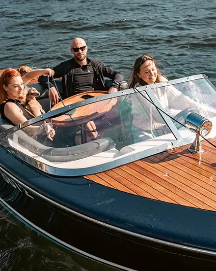 A group of people enjoying a ride in a speedboat on Lake Windermere