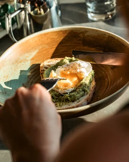 Vegetarian breakfast of poached egg and avocado on toast