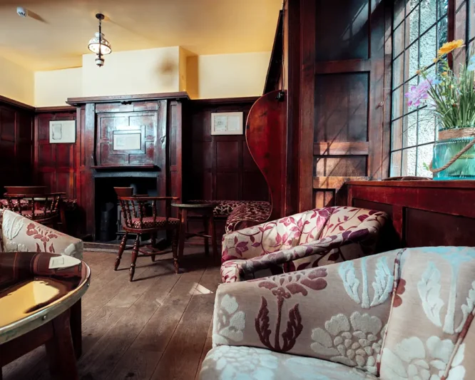Traditional country pub with wood panel walls and wood fire