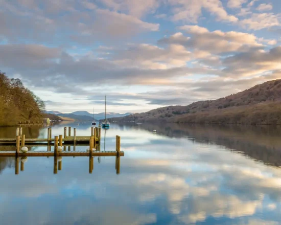 Serene view down Lake Windermere from Lakeside Hotel with the lake and fells and a dusk sky