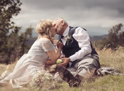 Newly married couple enjoy a picnic on the hillside near the hotel