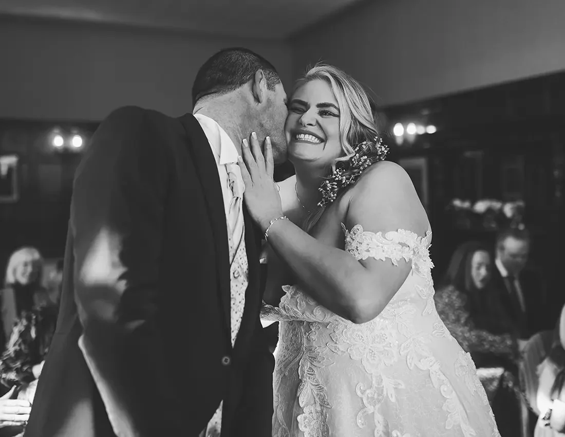 Happy couple embracing on dance floor at their evening reception at the Lakeside