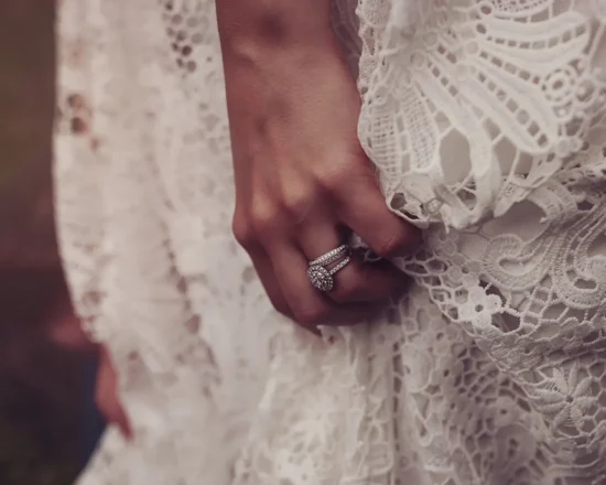 Close up of bride showing beautiful white dress and wedding ring