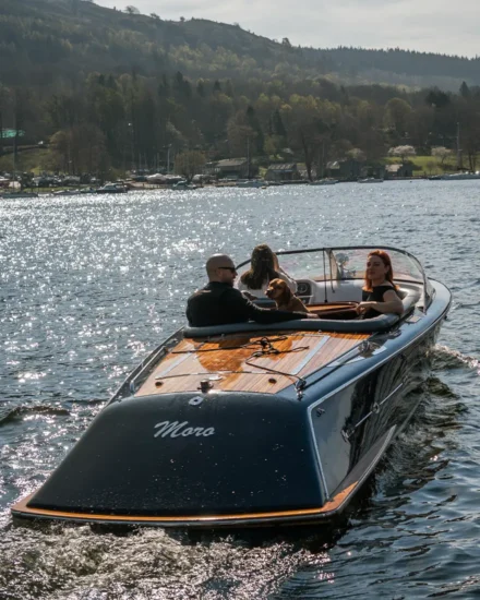 Hire boat view from behind as it sails across Lake Windermere