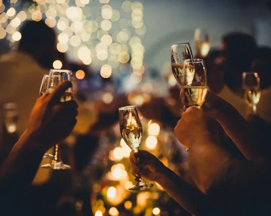 Party atmosphere as people raise glasses of champagne to bring in the New Year